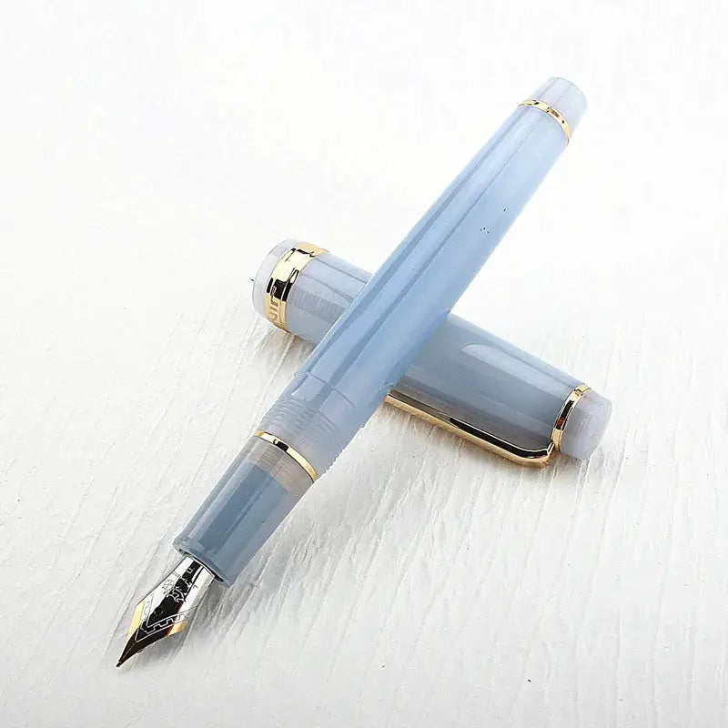 Jinhao 82 fountain pen in light blue acrylic with gold trim, bent nib, converter included; 2 pens