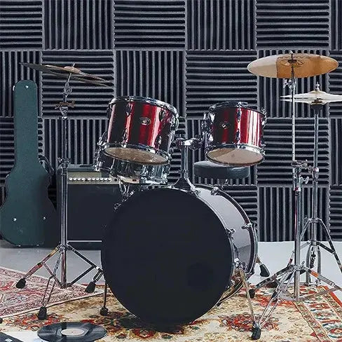 TOUO sound-absorbing foam panels for studio soundproofing; black acoustic tiles on the wall behind a drum kit