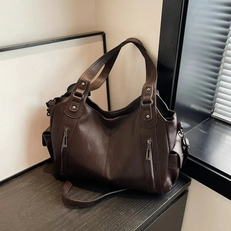 Shoulder bag by Simples Market in brown PU leather with dual top handles and front zip pockets
