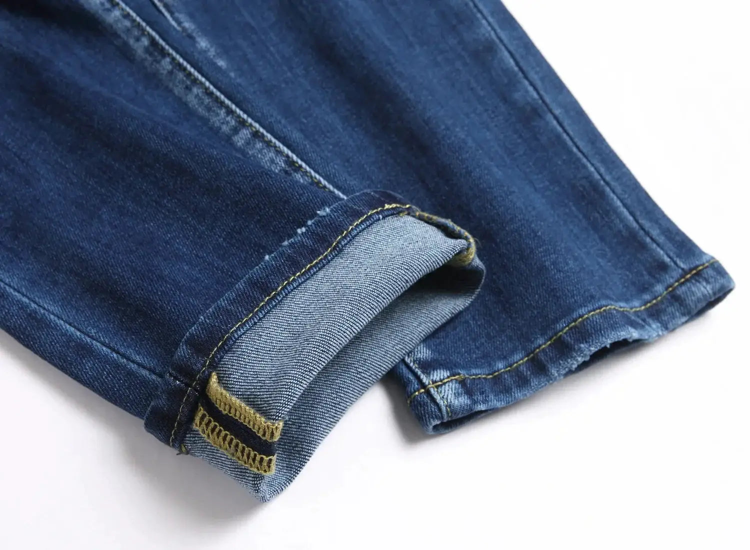 Men's light blue denim jeans with rolled cuffs and yellow contrast stitching