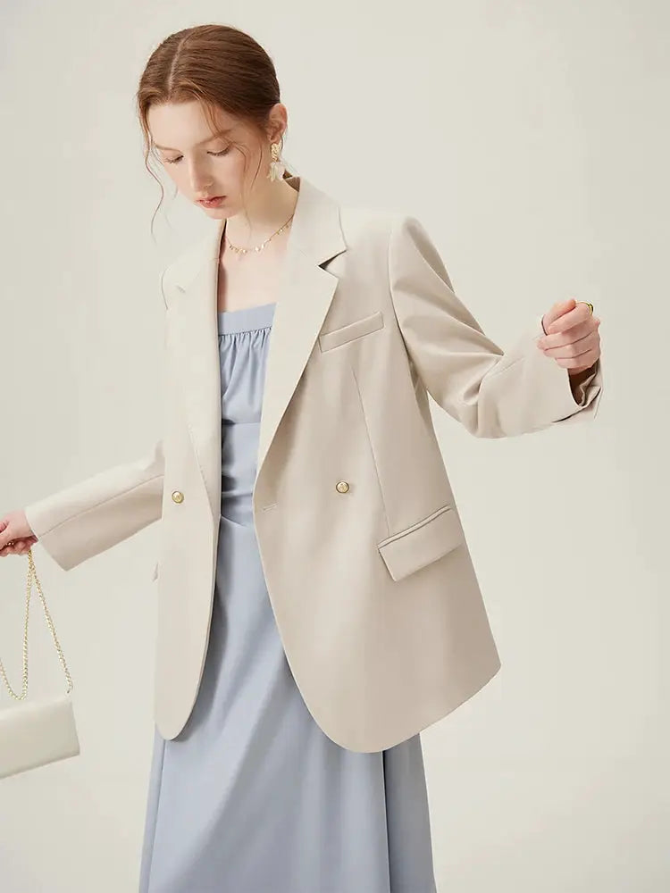 Women's beige blazer with light blue dress, office-ready suit set.