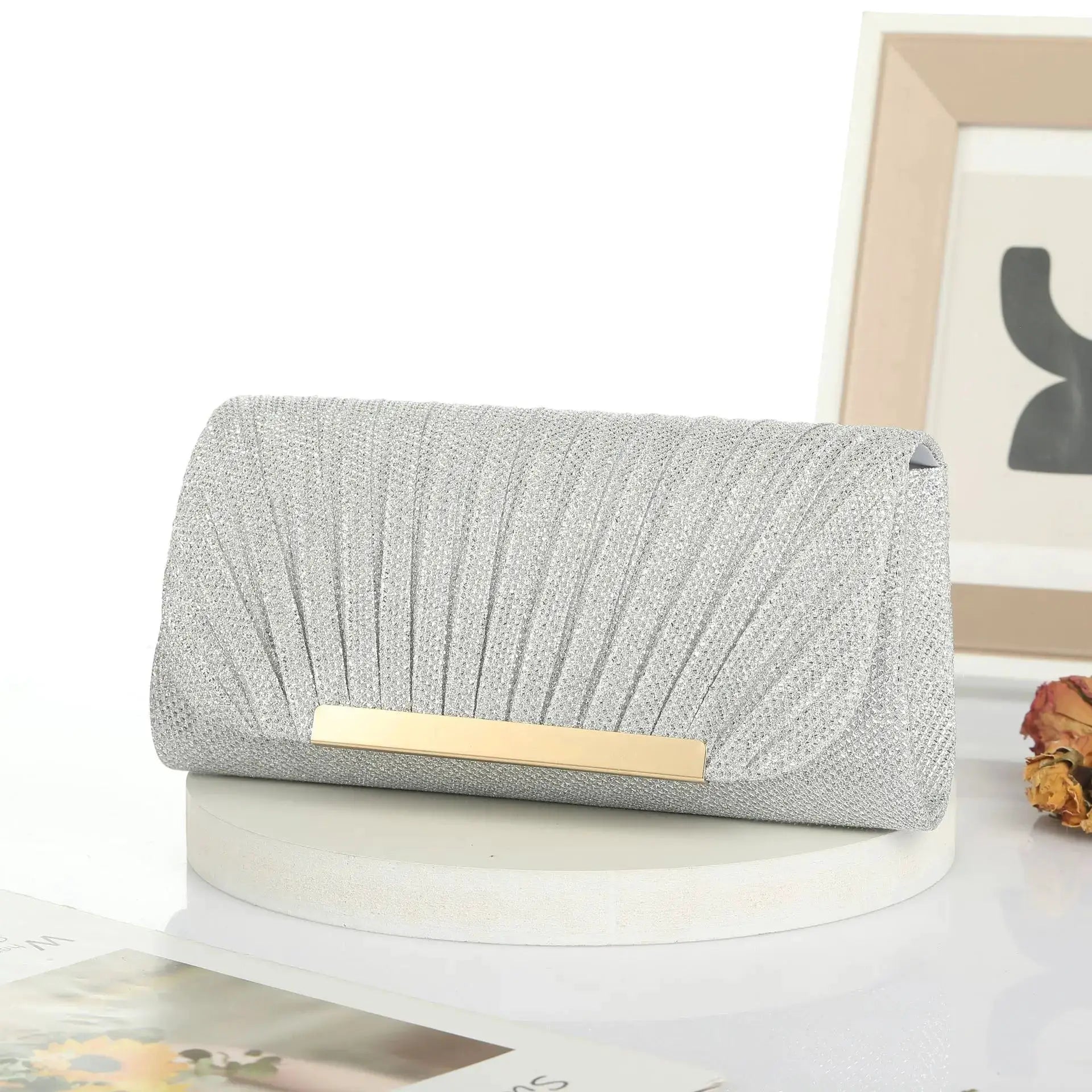 Silver sequined evening clutch with gold bar clasp, stylish party bag