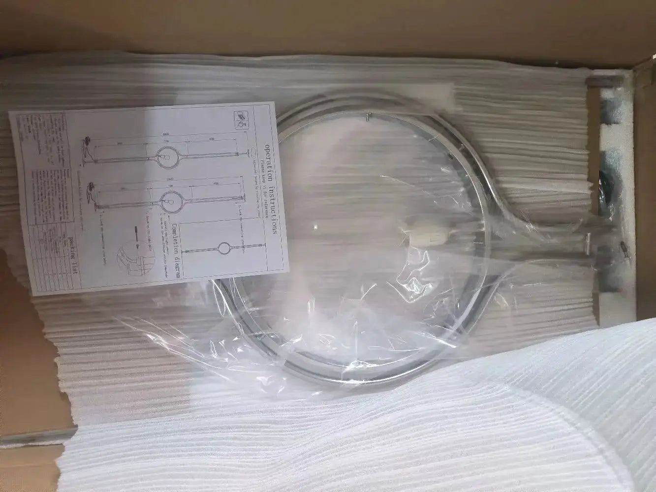 Modern white acrylic circular LED floor lamp by Simples Market in box with instructions