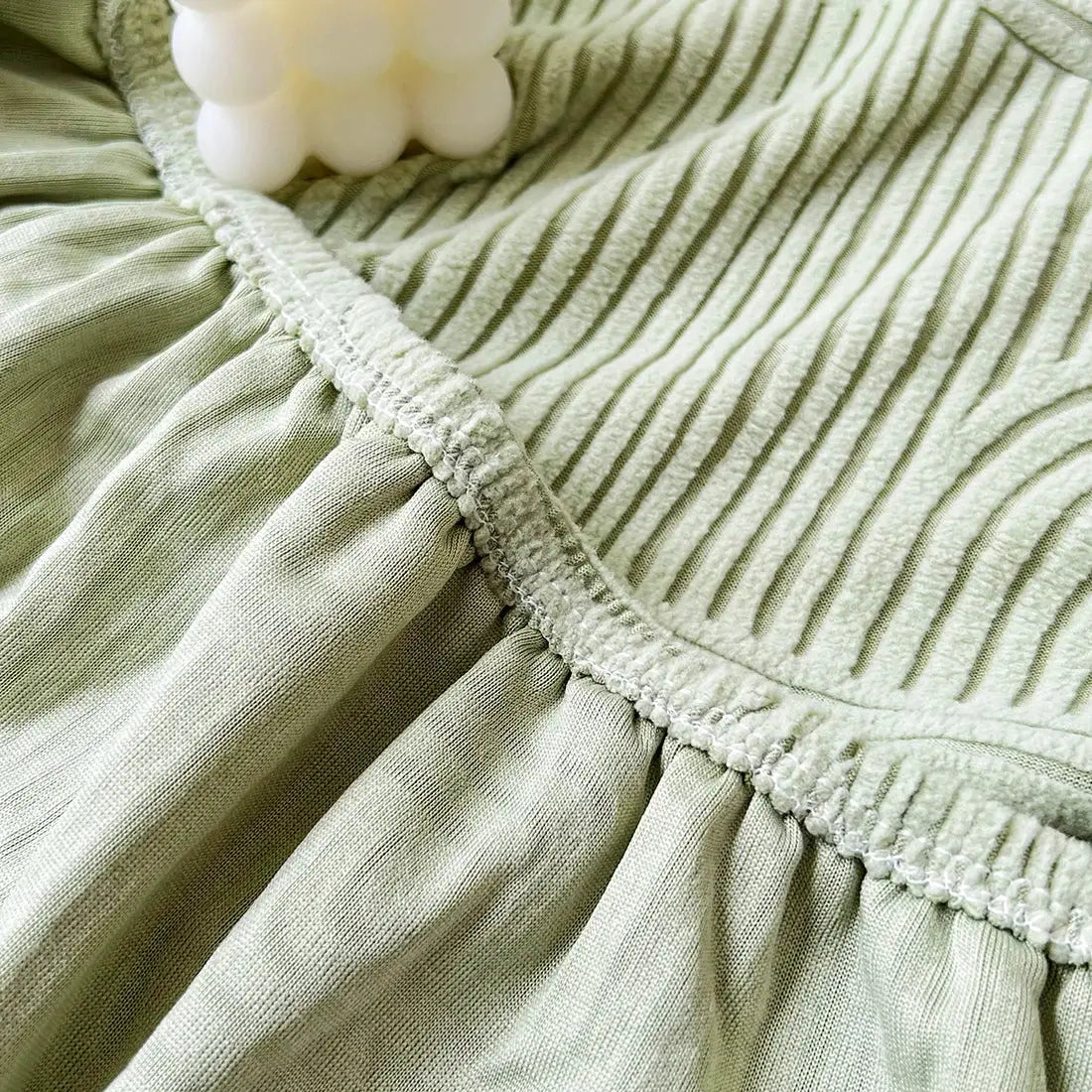 Sage green sofa cushion cover in thick stretch fabric with elastic edge