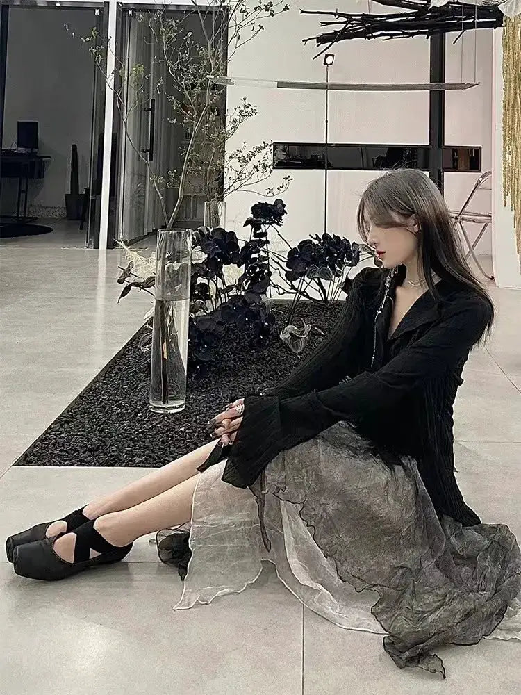 Karrram Gothic Black Shirt blouse; model wears sheer gray layered skirt and black platform sandals.