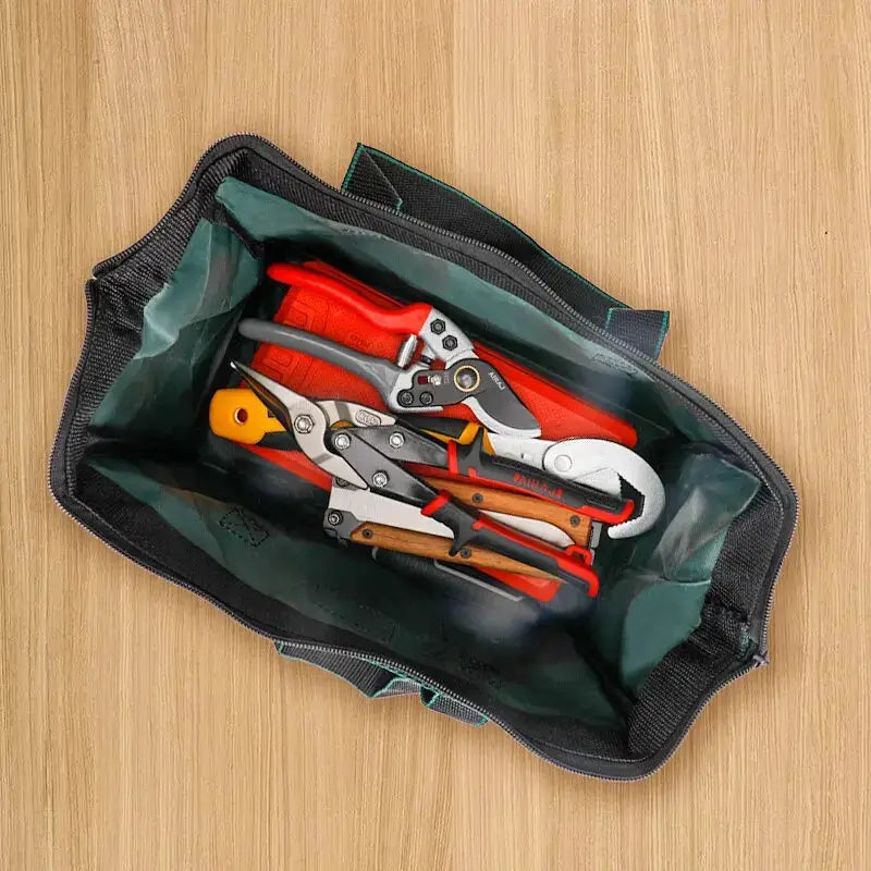 AIRAJ 13 Inch tool bag by Simples Market; black Oxford exterior with green lining, view of pliers and screwdrivers