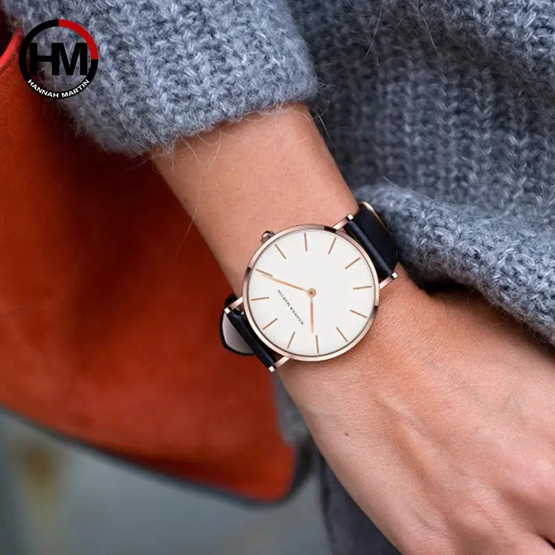 Hannah Martin women's waterproof wristwatch with rose-gold case, white dial, and black leather strap.