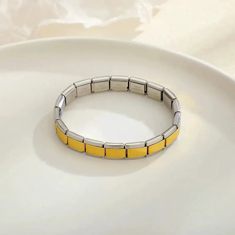 Unisex stainless steel bracelet with 9mm width, alternating silver and yellow enamel links on elastic band