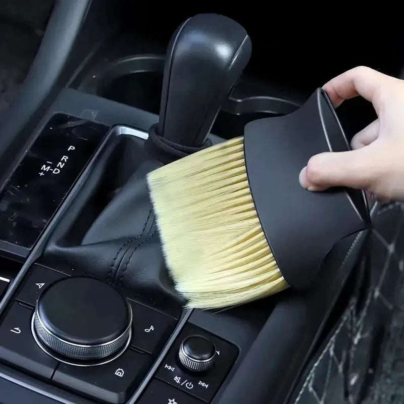 Car interior dust brush with beige soft bristles and black plastic handle for cleaning air vents and console