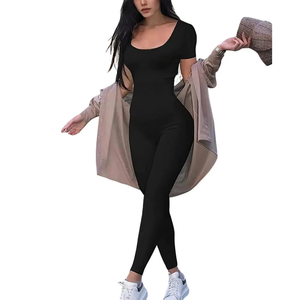 Women's black short-sleeve bodycon jumpsuit with beige jacket draped over shoulders