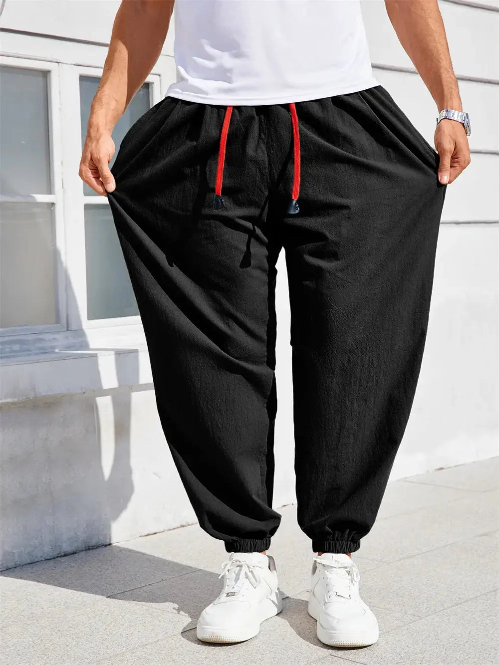 Men's loose-fit harem pants in black cotton-linen with red drawstring