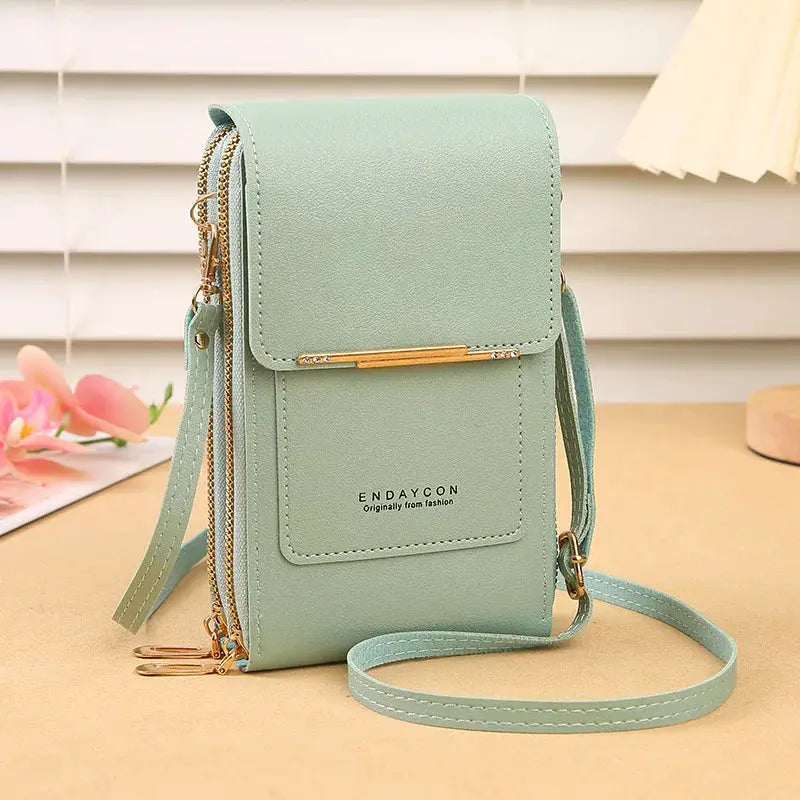Crossbody phone bag in mint green by Endaycon with front pocket and gold-tone hardware.