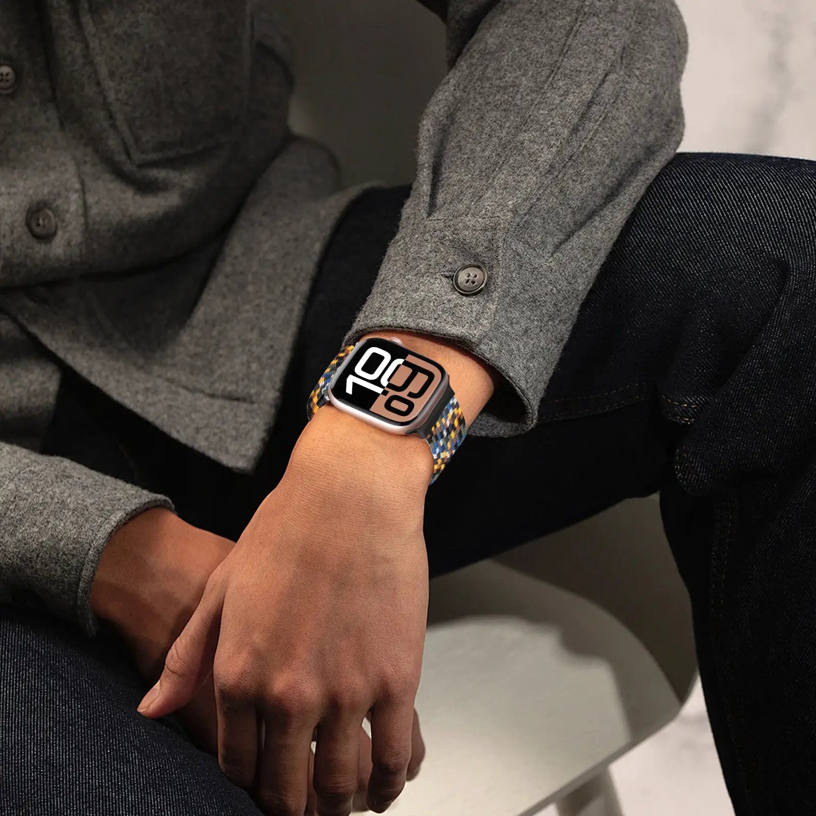 Apple Watch parachute strap braided bracelet in blue, yellow, and orange pattern