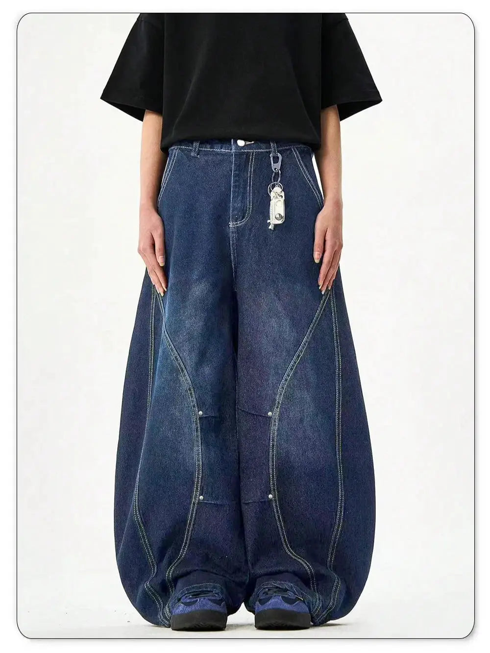Men's blue denim balloon jeans with wide legs, deconstructed panels, contrast stitching, belt-loop keychain