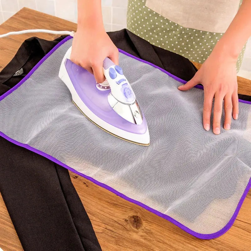 Clothes ironing protection pad with purple trim mesh cover on ironing board, Simples Market.