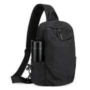 Simples Market men's chest bag in black canvas with bottle holder and crossbody strap.