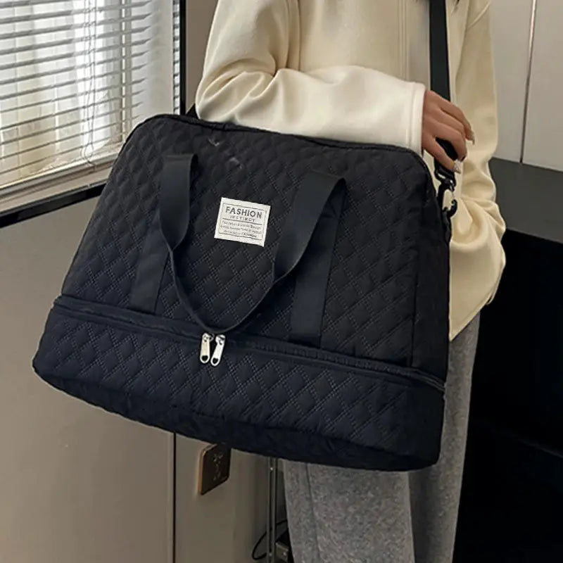 Duffle bag, black quilted fabric with dual handles and front zip pocket, FASHION emblem