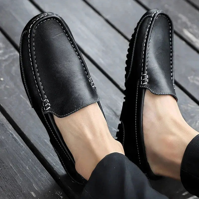 Genuine leather men's loafers, black slip-on with white stitching.