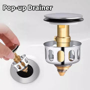 Basin pop-up drain assembly with metal filter valve in chrome and brass tones by Simples Market.
