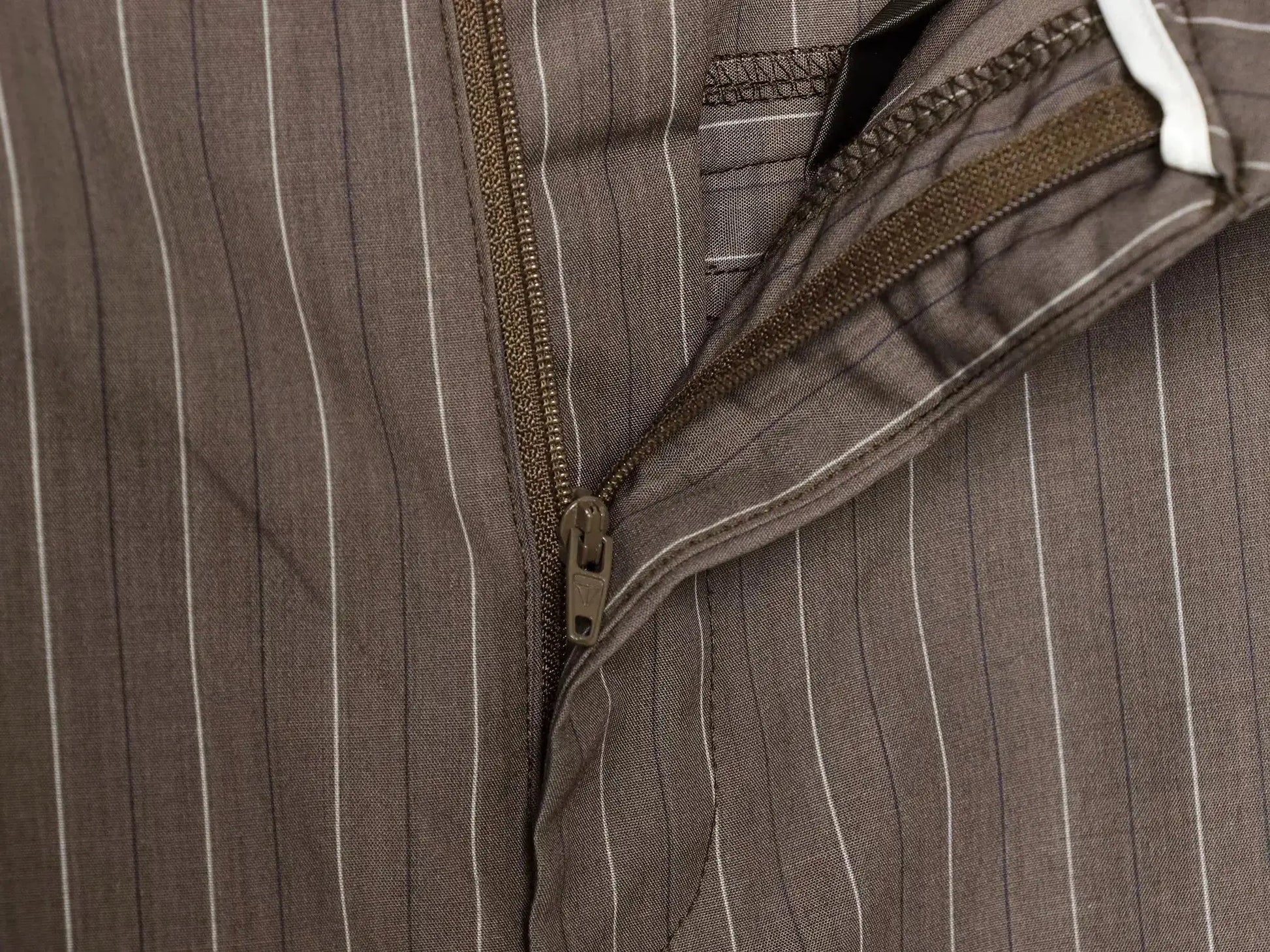 Brown pinstriped office blazer with zipper closure and pocket detail.
