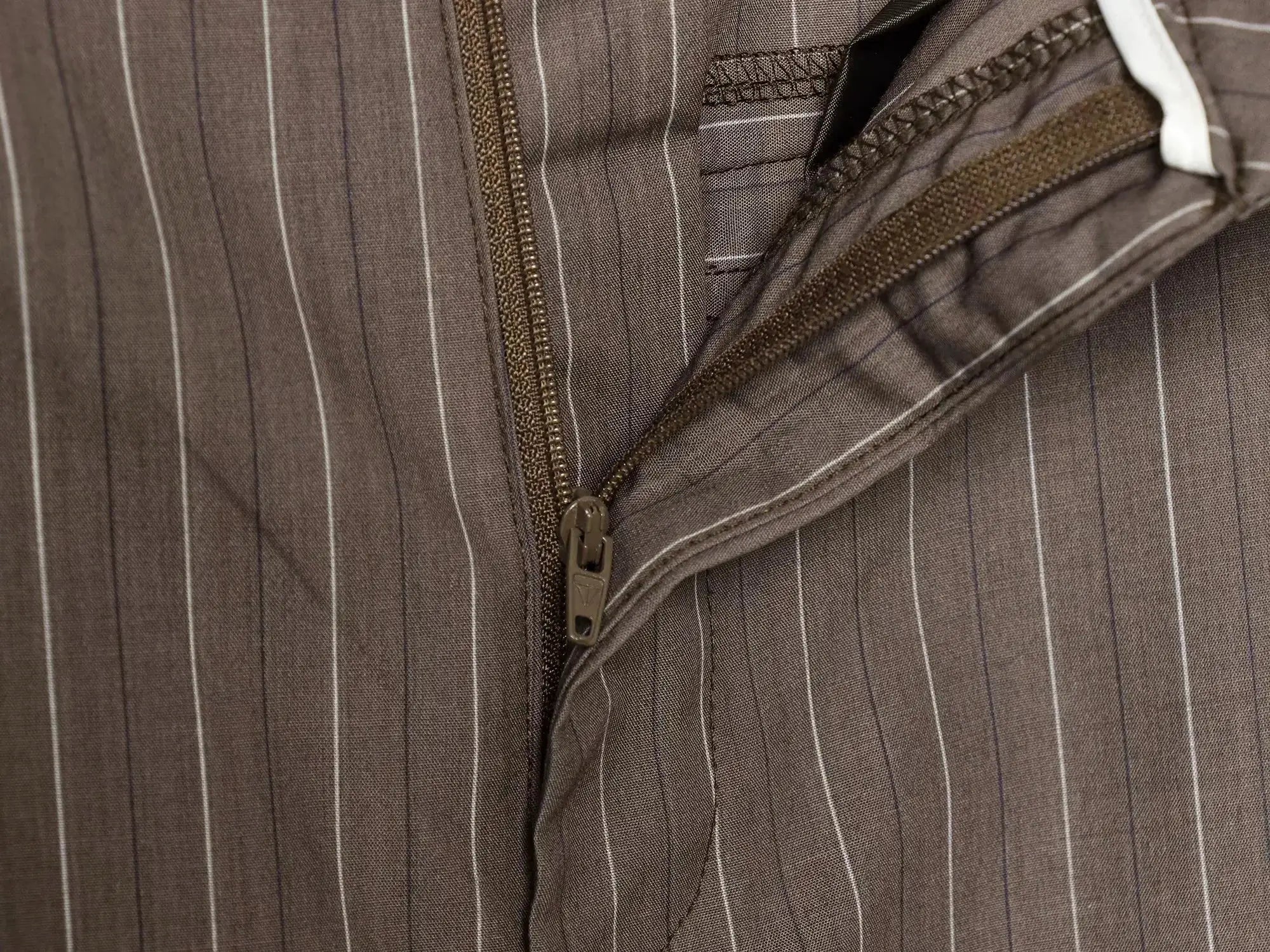 Brown pinstriped office blazer with zipper closure and pocket detail.