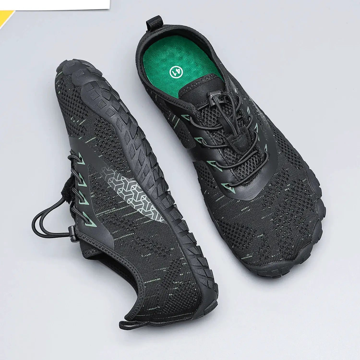 Simples Market minimalist barefoot trail running shoes, black with green accents, wide-width pair