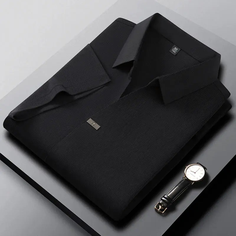 Men's black polo shirt and watch; solid-color short-sleeve polo on folded display