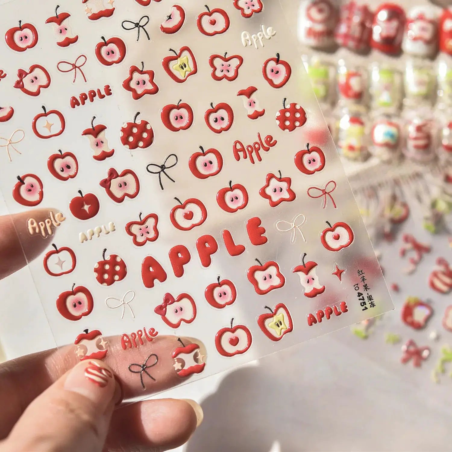 Nail art stickers sheet by Simples Market, pink translucent jelly texture, red apple fruit decals