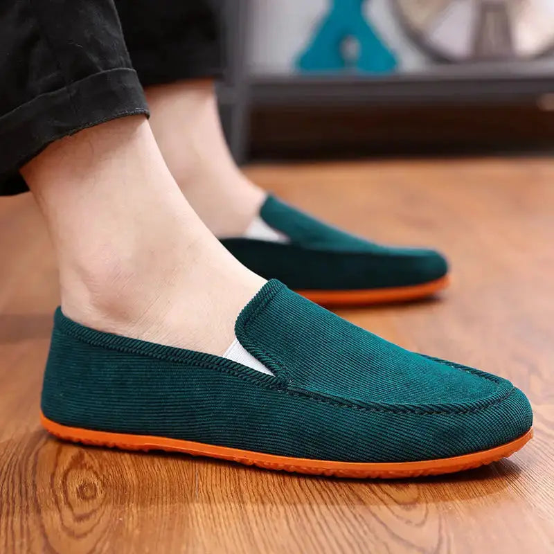 Men's teal fabric slip-on loafers with orange sole, casual driving shoes.