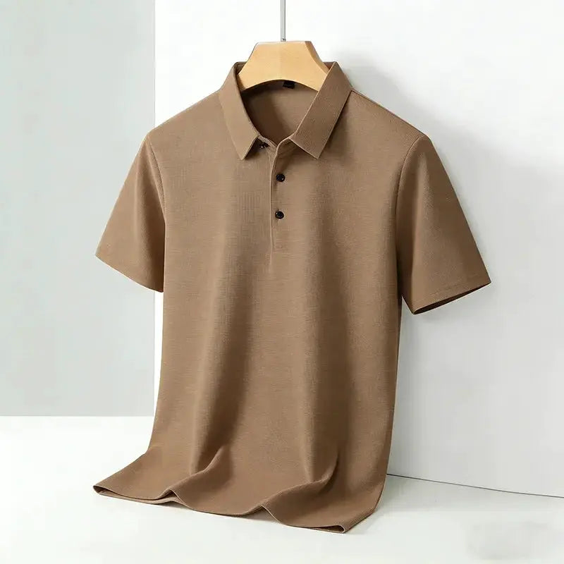 Tan polo shirt with classic collar and short sleeves on a hanger
