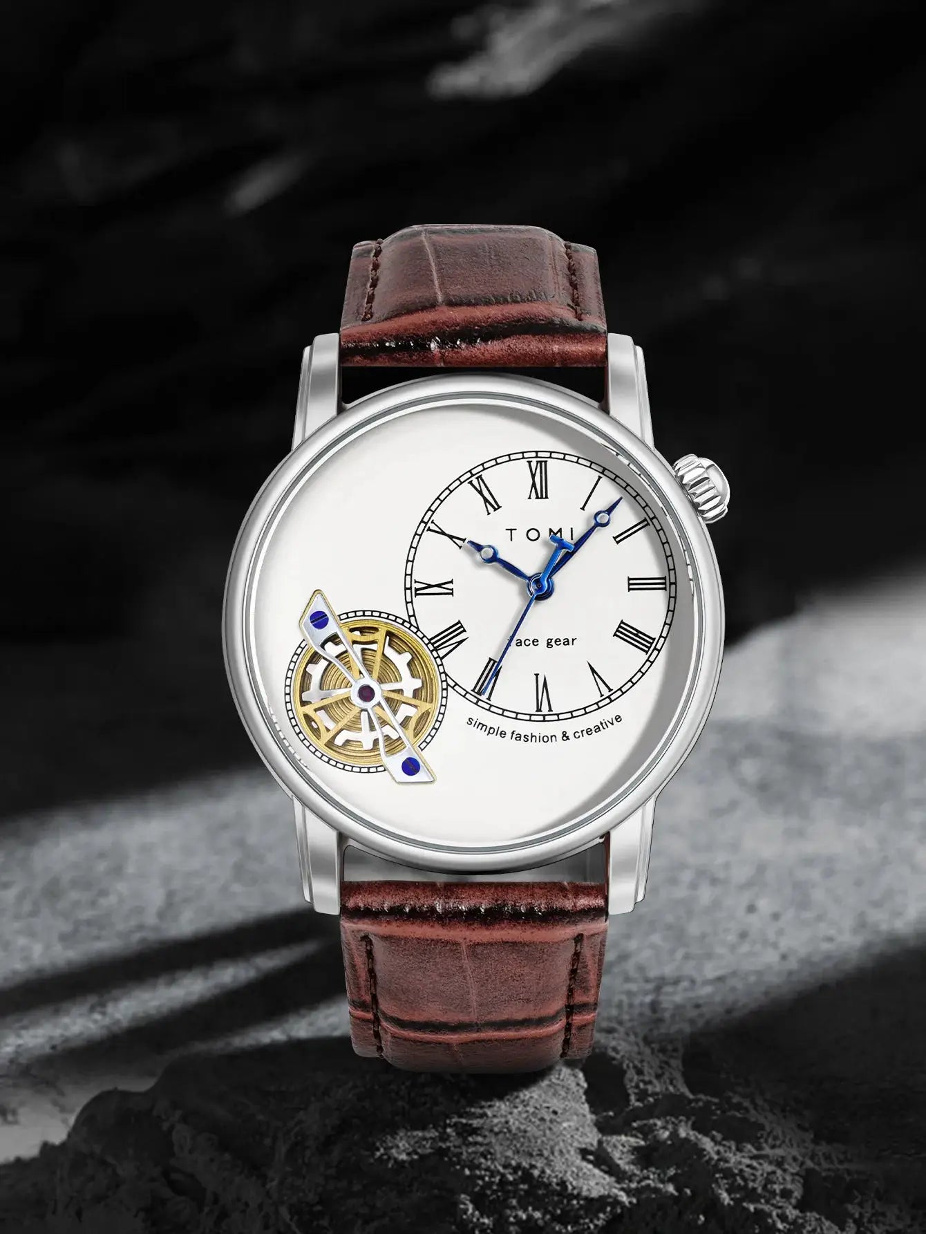 TOMI men's quartz watch with brown leather strap, silver case, white Roman numeral dial with blue hands and visible gear