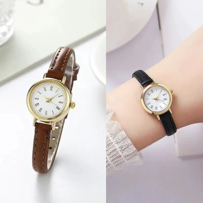 Two women's watches with gold-tone cases and leather straps (brown and black) featuring Roman numeral dials.