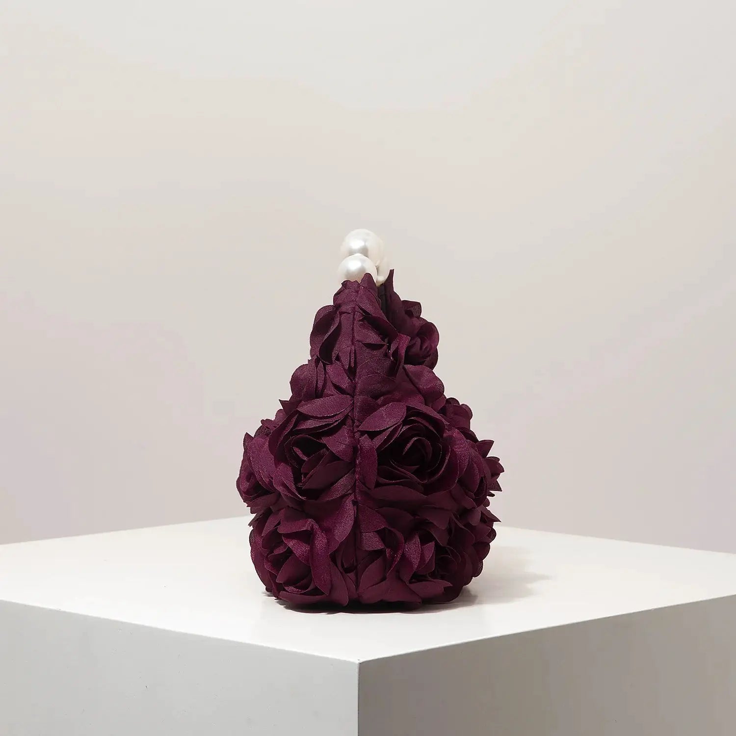 Floral burgundy petal-clad clutch with pearl handle for elegant events