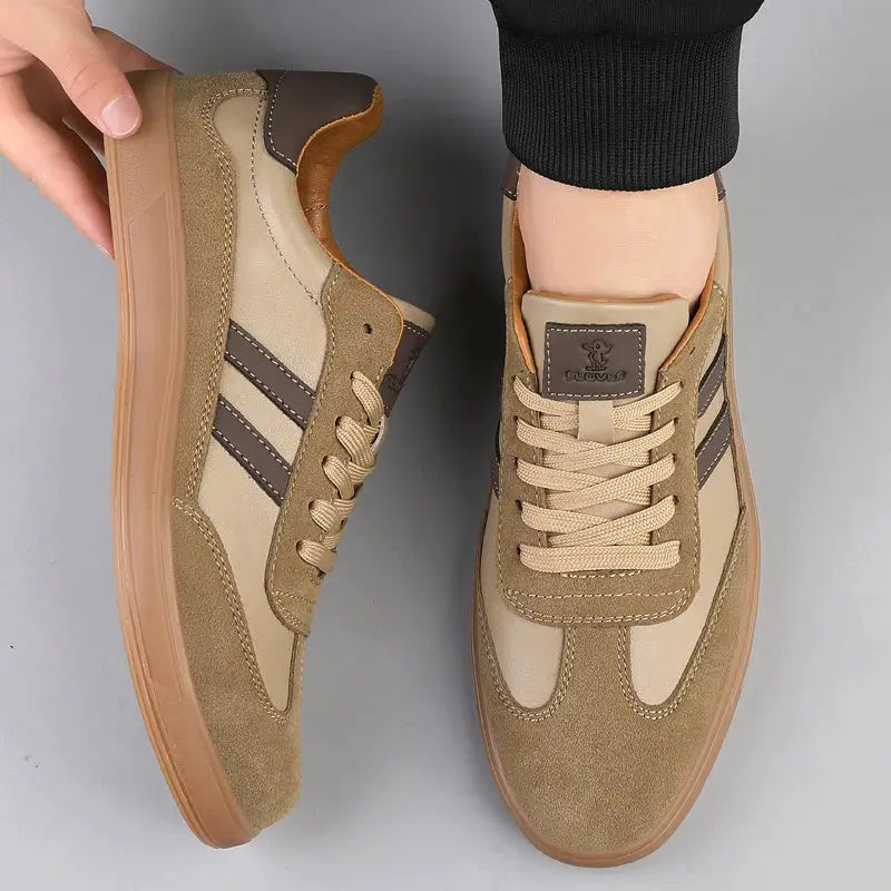 Leather sneakers by Simples Market, beige pair with dark side stripes and tan suede overlays, gum sole.