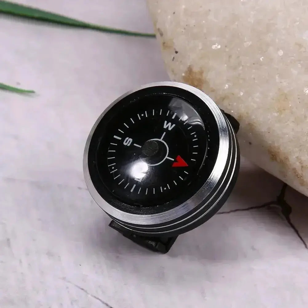 Mini watch-strap button compass for paracord bracelet, black dial with silver bezel.