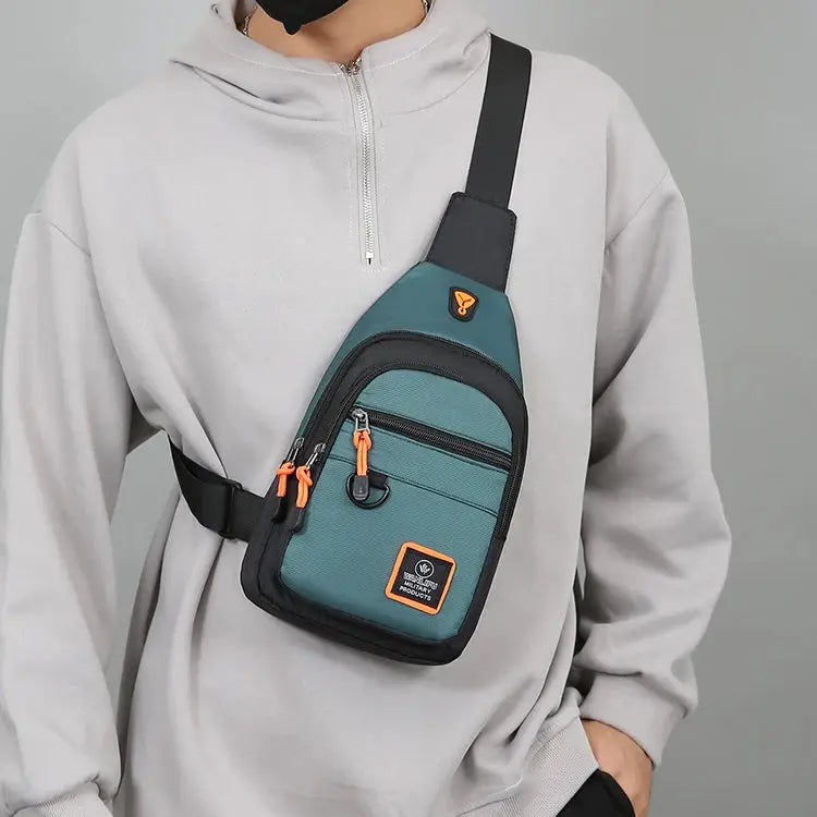 Simples Market men's teal crossbody bag with black trim and orange zipper pulls