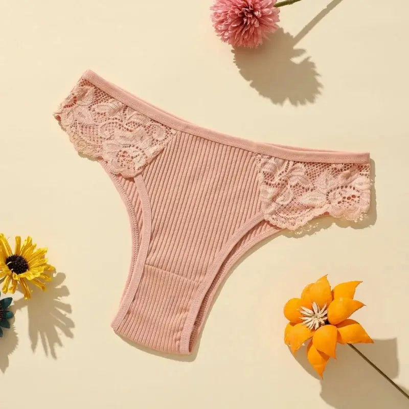 Pink ribbed cotton women's panties with floral lace side panels and a low-rise bikini fit.