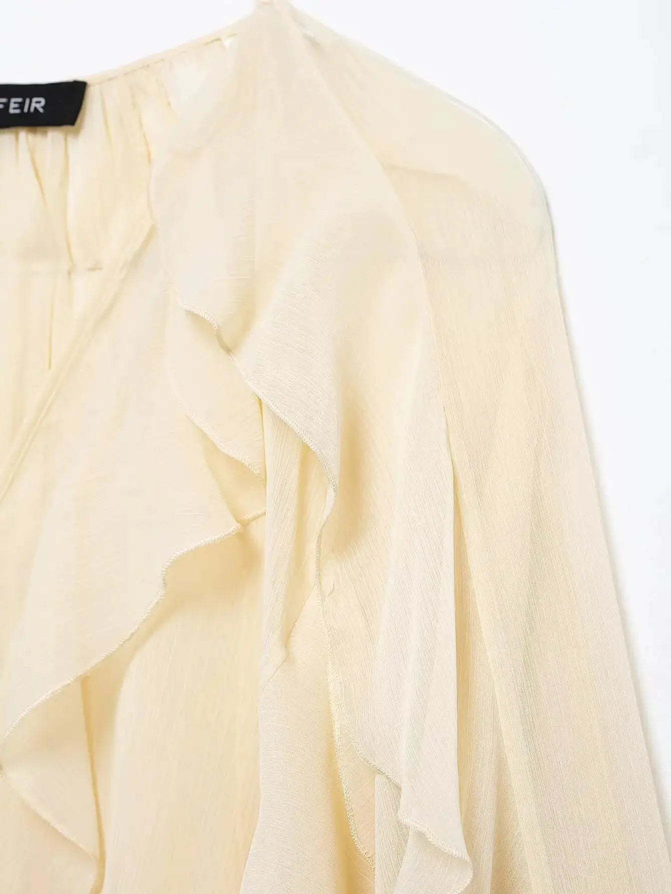 Women's ivory ruffled blouse with cascading front ruffles and lightweight crepe fabric; FEIR tag visible