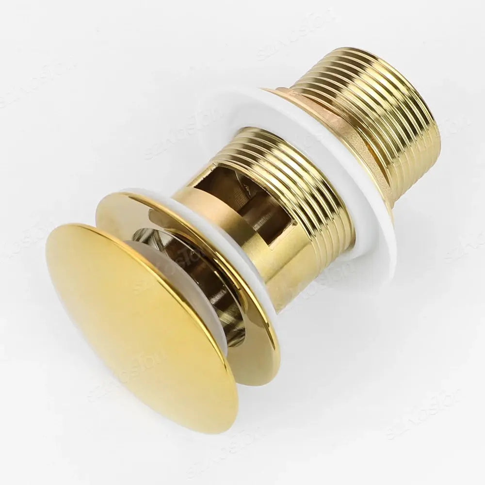 Gold pop-up bathroom sink drain stopper with threaded brass body and white gasket for washbasin