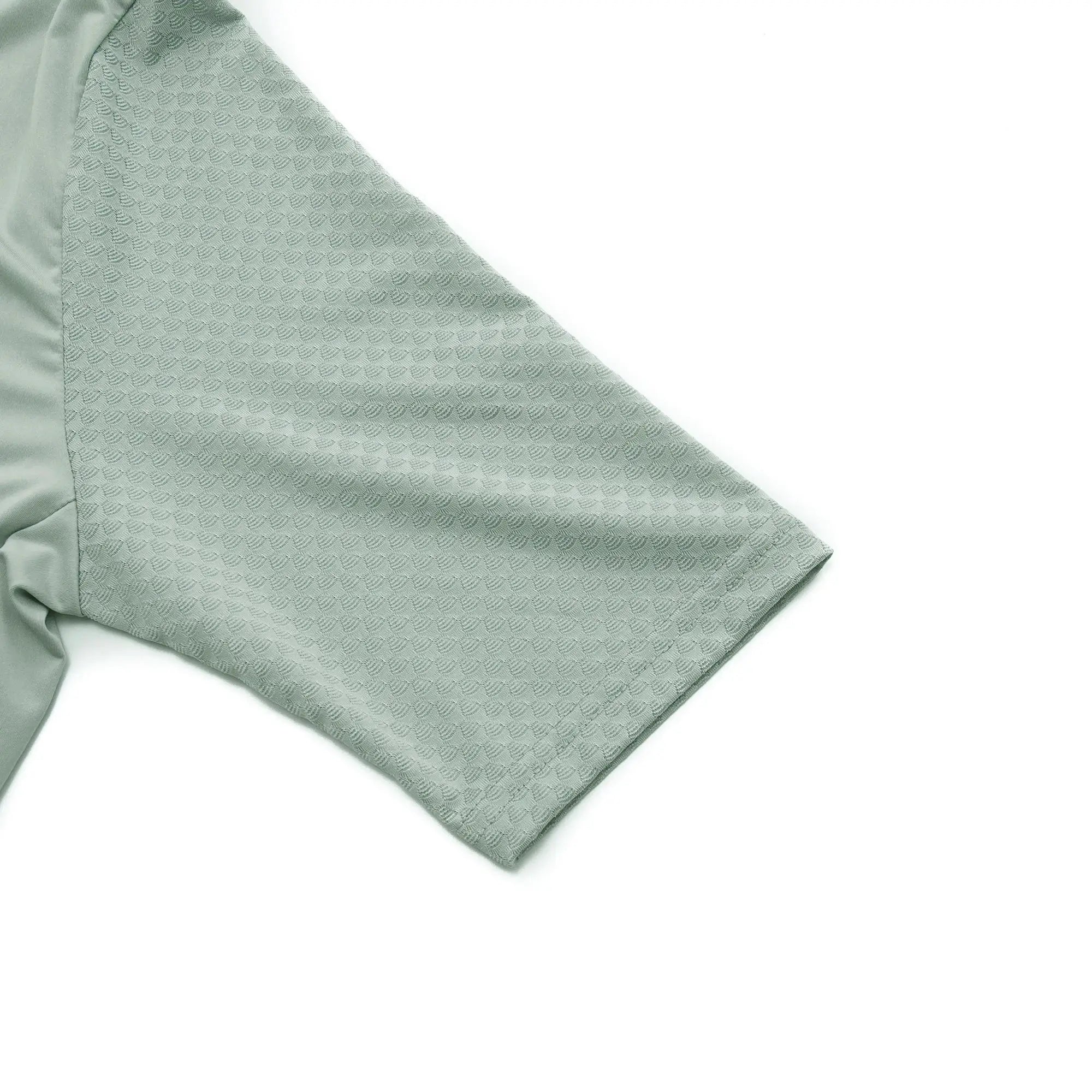 Men's cycling jersey sleeve in light sage green breathable textured fabric.