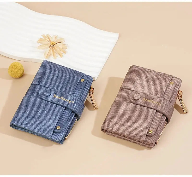 Two Baellerry denim wallets in blue and pink with zipper coin pocket and detachable card clip