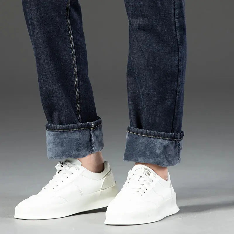 Men's dark blue fleece-lined denim jeans with rolled cuffs, casual straight-leg work trousers.