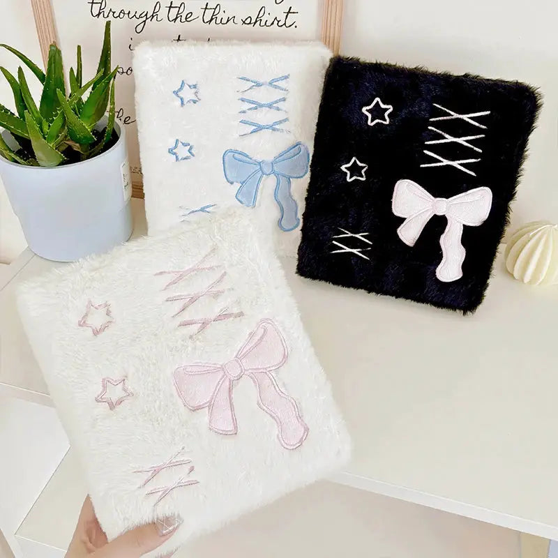 A6 binder photocard holder set by Simples Market; three plush binders in white, blue, and black with pastel bows