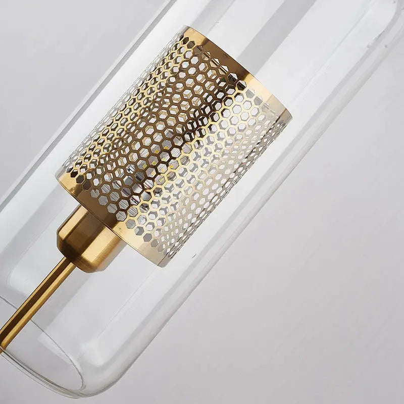 Modern glass wall lamp by Simples Market with a gold metal mesh sleeve