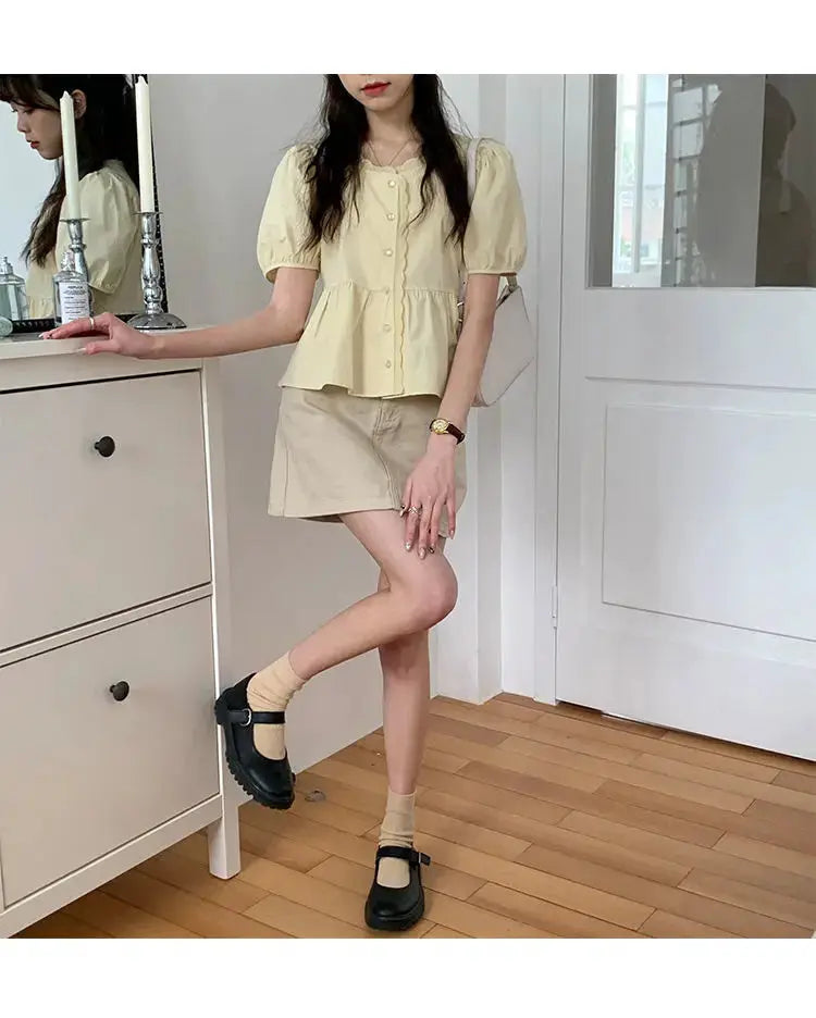 Women's short puff-sleeve peplum top in pale yellow with button-front for cute summer style