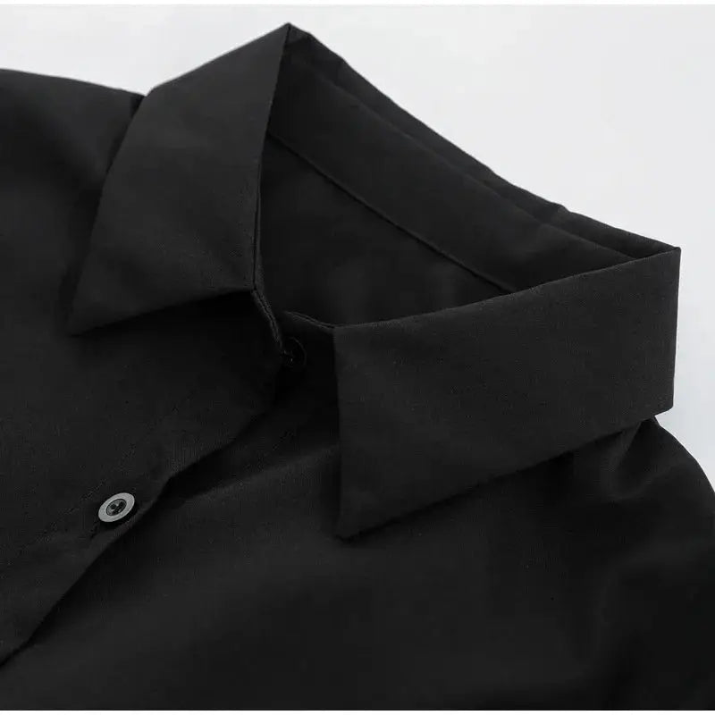 Women's black shirt blouse with lapel collar, solid color, single-breasted front, close-up of neckline.