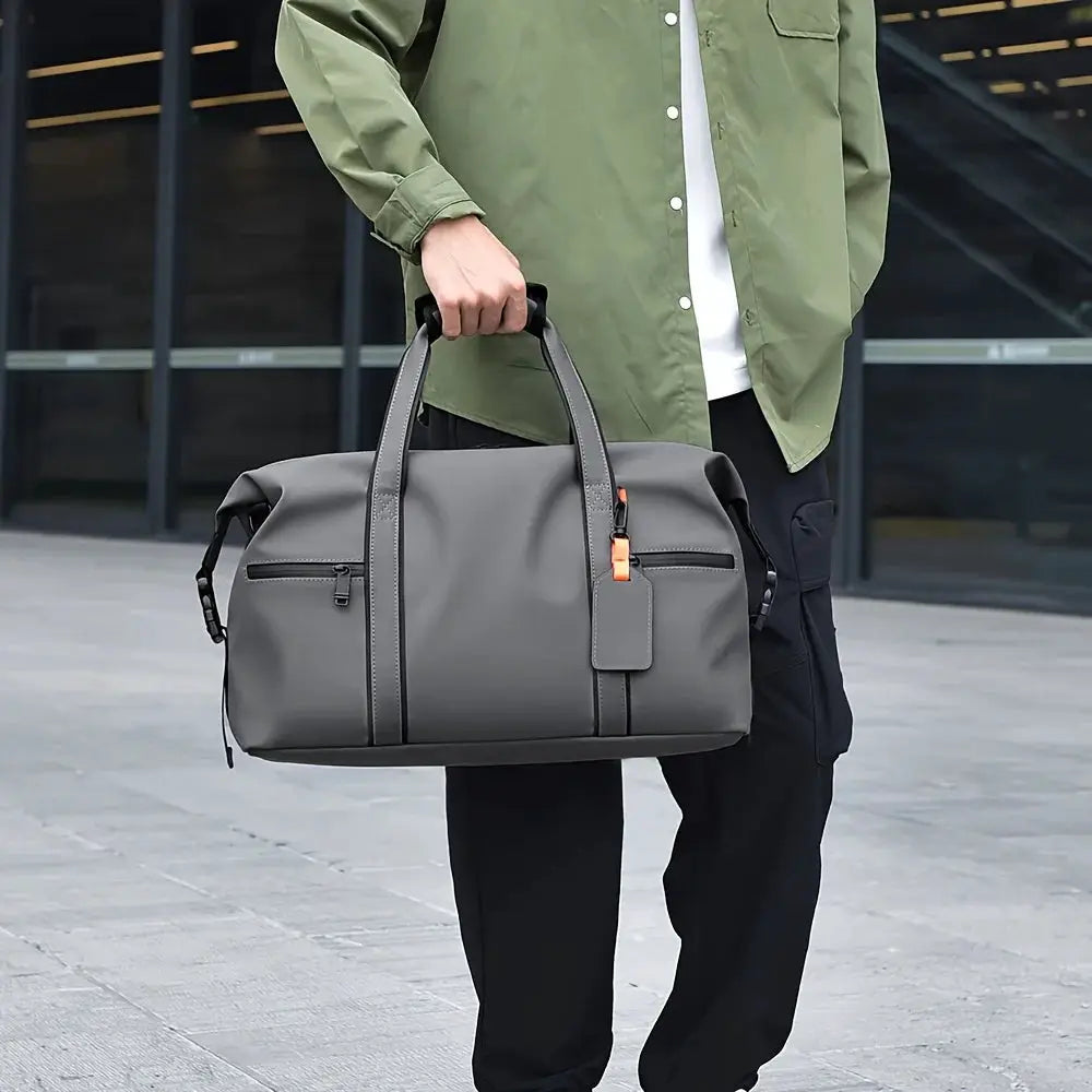 Large capacity travel duffel bag in gray with black handles and orange zipper pull.