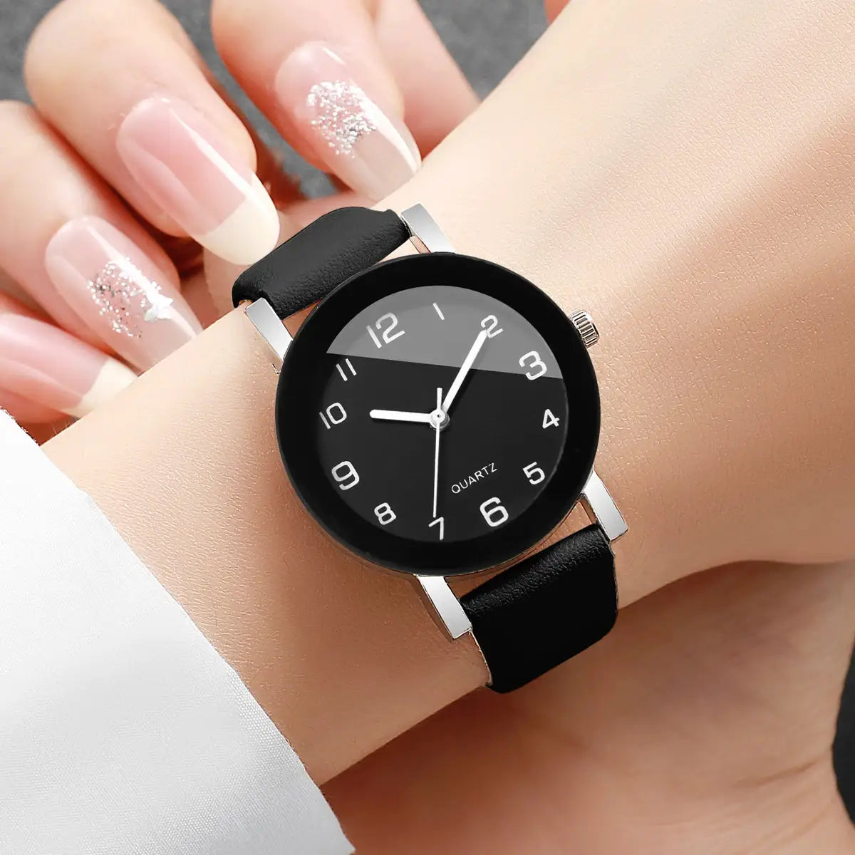 Watch with black leather strap, silver case, quartz movement, black dial with white Arabic numerals
