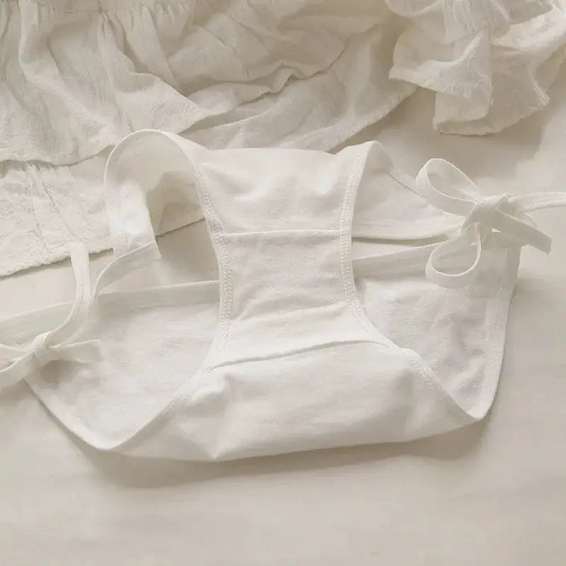 White lace-up briefs for women with side bows and low-waist design