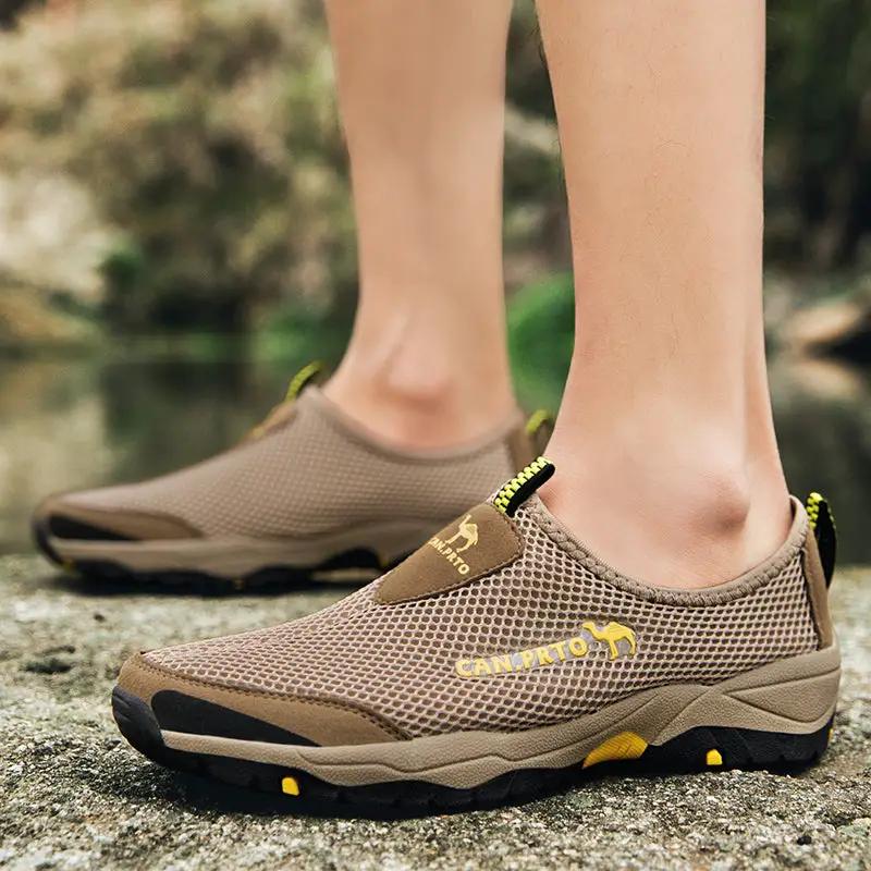 Pair of men's tan mesh slip-on shoes with breathable upper and rugged outsole